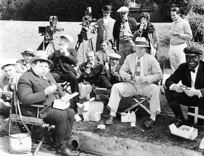 Harry, center wearing a white hat, on location with actor Charles Puffy, left foreground.