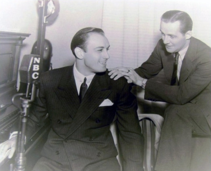 Fidler, right, and actor/singer Russ Columbo in the NBC radio studio, Los Angeles, 1934.